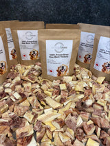 Artisan Raw GO! sampler box with freeze-dried raw bison tendons in brown packaging on a bed of dried meat pieces.